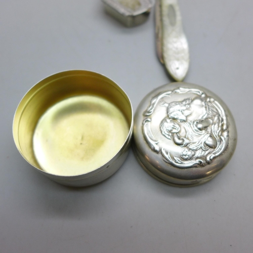 7343 - Nine pieces of silver including a Victorian jug, a pot with embossed figures to lid, an egg cup, a s... 