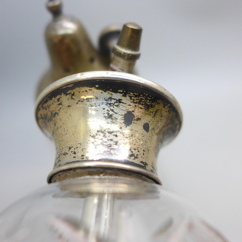 7358 - A cut glass sugar caster with a silver top, silver 18g, and a scent bottle with silver top, a/f