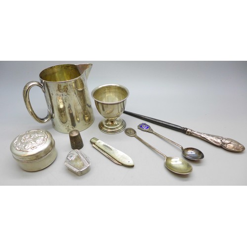 7343 - Nine pieces of silver including a Victorian jug, a pot with embossed figures to lid, an egg cup, a s... 