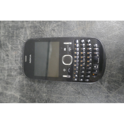 5007 - An apple iphone 5s with charging cable and a nokia mobile phone