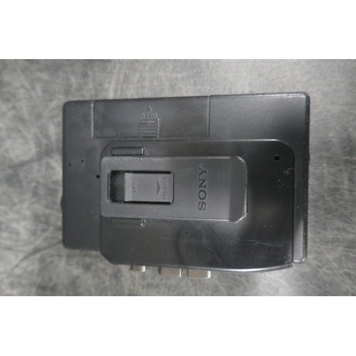 5011A - A vintage Sony Walkman WMFX24/FX37 cassette player with a Sony Walkman travel pouch