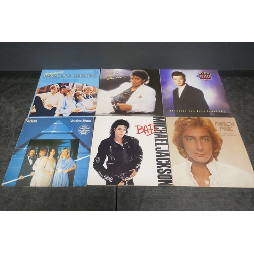 5017 - A quantity of assorted records including Michael Jackson Thriller, Rick Astley, The Nolans, etc.