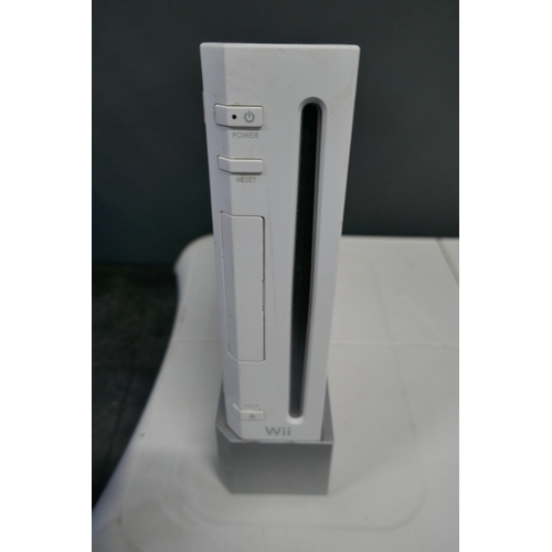 5019 - A Nintendo Wii games console with base, power supply, sensor bar and AV cables - no remotes  * This ... 