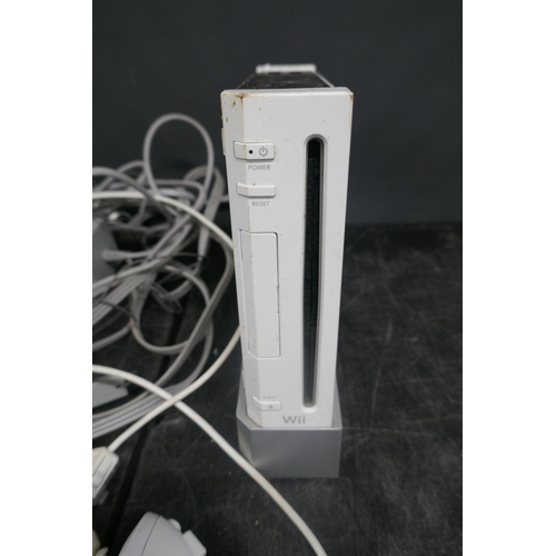 5020 - A Nintendo Wii games console with base, power supply, sensor bar, AV cables, Wii motion controllers ... 