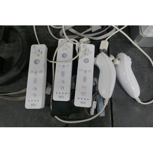 5020 - A Nintendo Wii games console with base, power supply, sensor bar, AV cables, Wii motion controllers ... 
