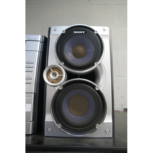5054 - A Sony HCD-RG270 compact disc deck receiver with 3-disc changer, double cassette deck and radio with... 