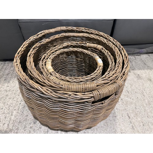 3208 - A set of four circular wicker storage baskets