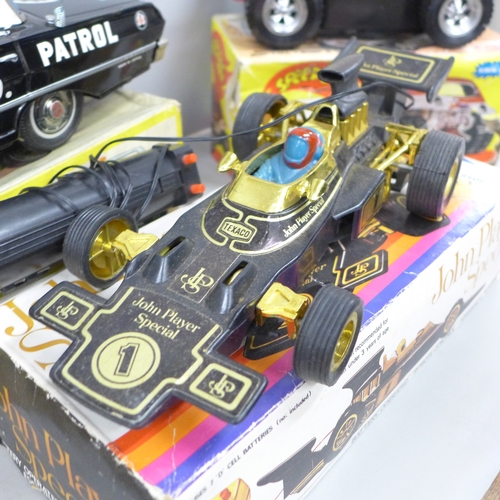 2059 - Three battery operated model cars, John Player Special, a Japan made Highway Patrol Car and Speed Bu... 