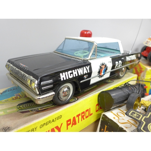 2059 - Three battery operated model cars, John Player Special, a Japan made Highway Patrol Car and Speed Bu... 