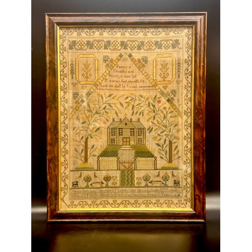 2250 - A 19th Century sampler, embroidered with lettering, house and foliate design, framed, 51cm x 39cm