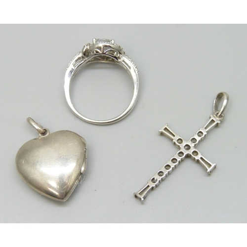 7140 - A silver ring, R, a white metal heart locket, and a silver cross pendant, 12g