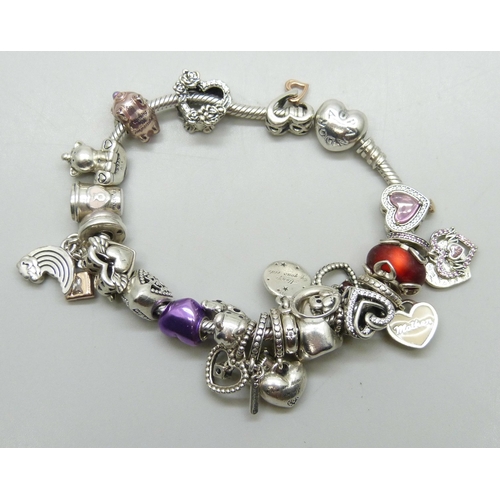 7145 - A Pandora silver bracelet with a collection of silver and white metal charms, most Pandora, some unm... 