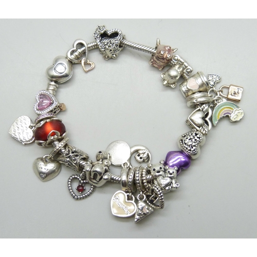 7145 - A Pandora silver bracelet with a collection of silver and white metal charms, most Pandora, some unm... 