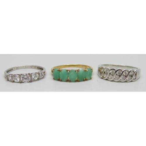 7151 - Three silver rings including a gilt emerald example, 7.5g total