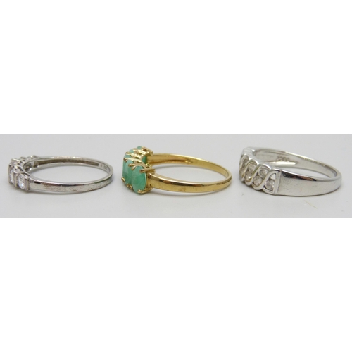 7151 - Three silver rings including a gilt emerald example, 7.5g total