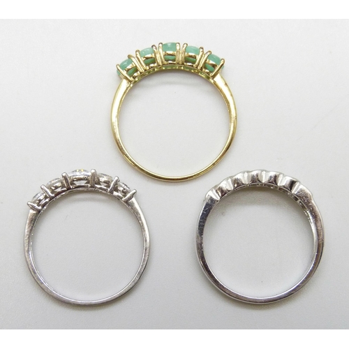 7151 - Three silver rings including a gilt emerald example, 7.5g total