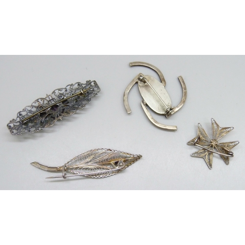 7162 - Four white metal brooches including a floral example, 14g