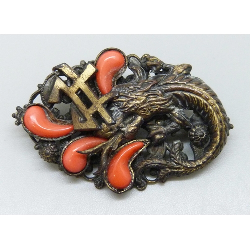 7165 - An Art Deco Neiger Brothers brooch in the form of a Chinese dragon set with faux coral, 4.1cm
