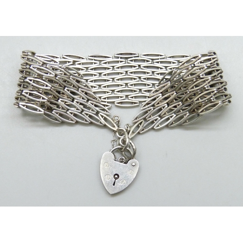 7169 - A 1970s silver Modernist design gate bracelet, 40g, 2.2cm