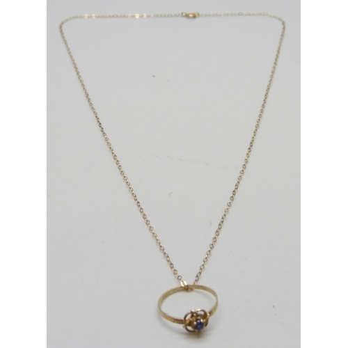 7171 - A small gold ring on a 9ct gold chain, 0.7g total