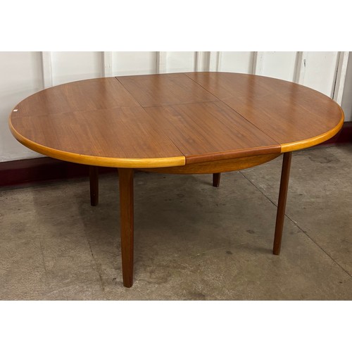 50 - An Elliot's of Newbury teak circular extending dining table and four chairs