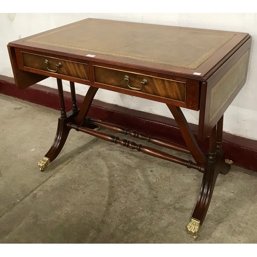 103 - A Regency style mahogany and green leather topped drop-leaf sofa table
