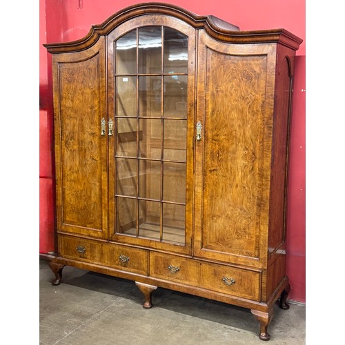 74 - A Queen Anne style figured walnut triple wardrobe