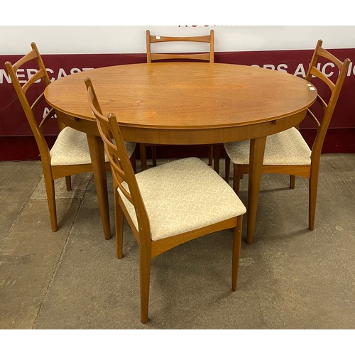 22 - A Greaves & Thomas teak oval extending table and four chairs