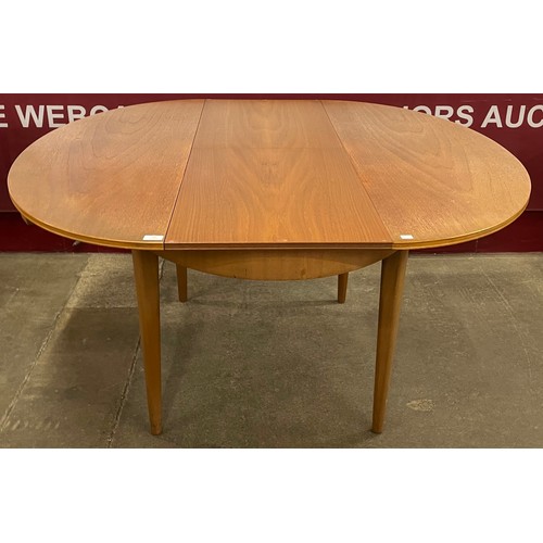 22 - A Greaves & Thomas teak oval extending table and four chairs