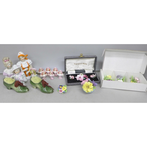 2143 - Two china brooches with a matching pair of earrings, two shoe pin cushions, a china posy, four large... 