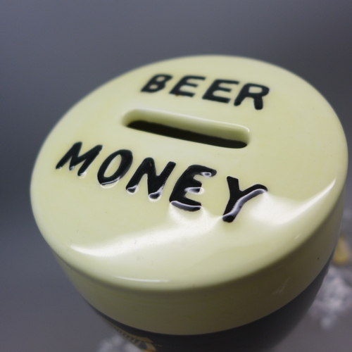 2290 - A Guinness novelty money box and three badges