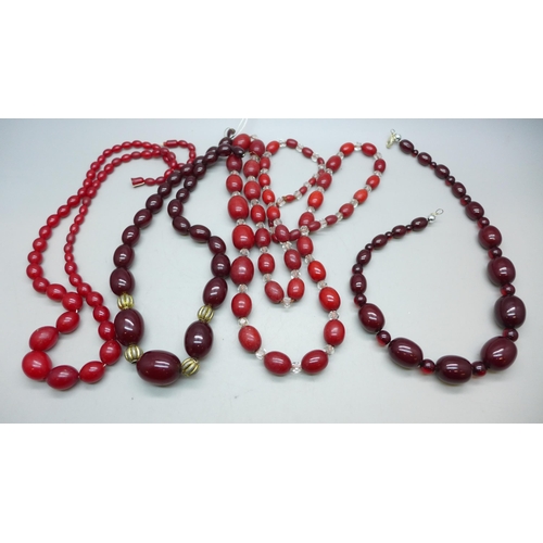 7296 - Two Bakelite bead necklaces, 80g combined (spacers on one not Bakelite), and two other red bead neck... 
