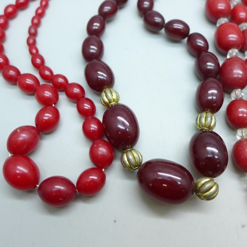 7296 - Two Bakelite bead necklaces, 80g combined (spacers on one not Bakelite), and two other red bead neck... 