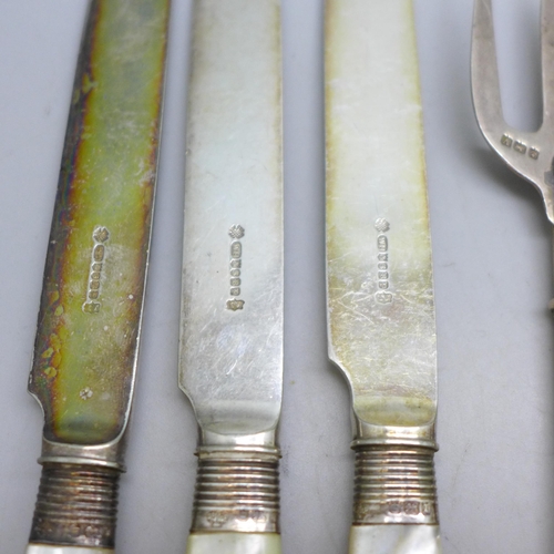 7396 - A collection of silver plated knives and forks with mother of pearl handles, a silver fork example, ... 