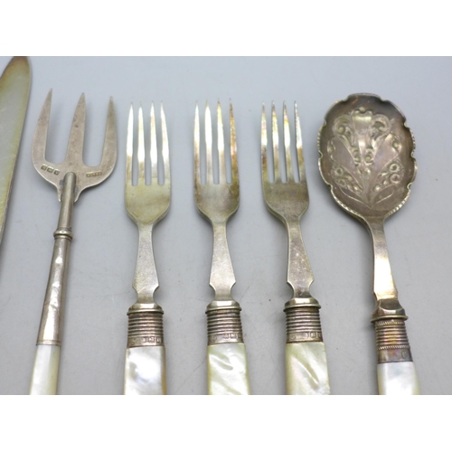 7396 - A collection of silver plated knives and forks with mother of pearl handles, a silver fork example, ... 