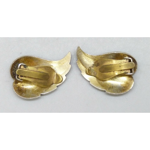 7049 - Ivar T Holth, A pair of silver gilt clip on Norwegian earrings in the form of leaves with blue ename... 