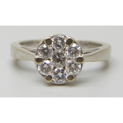 7147 - An 18ct white gold ring set with seven diamonds, 5g, N