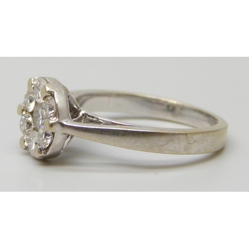 7147 - An 18ct white gold ring set with seven diamonds, 5g, N
