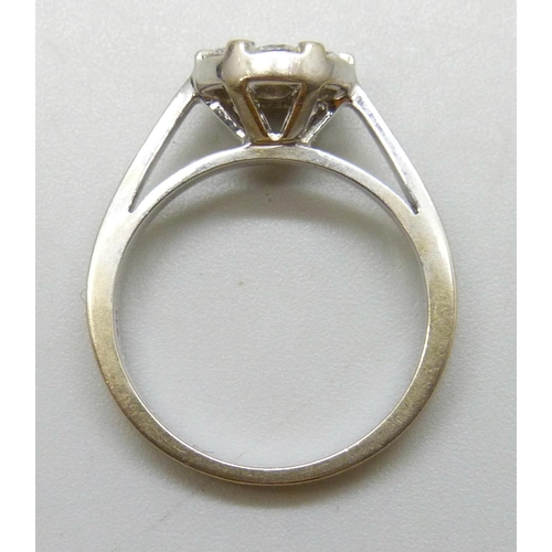 7147 - An 18ct white gold ring set with seven diamonds, 5g, N