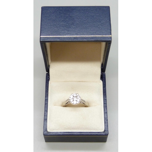 7147 - An 18ct white gold ring set with seven diamonds, 5g, N