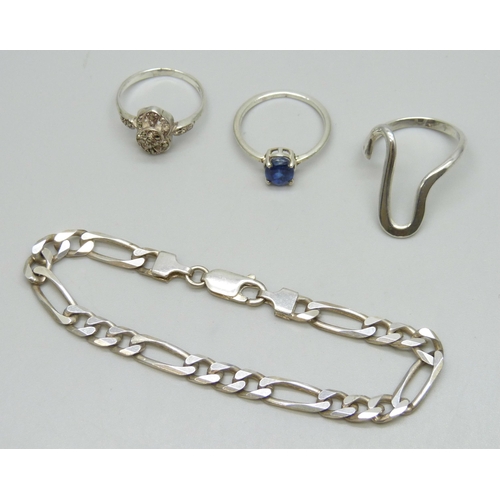 7153 - An Italian silver curb link bracelet, two white metal rings, and a silver ring, all test as silver, ... 