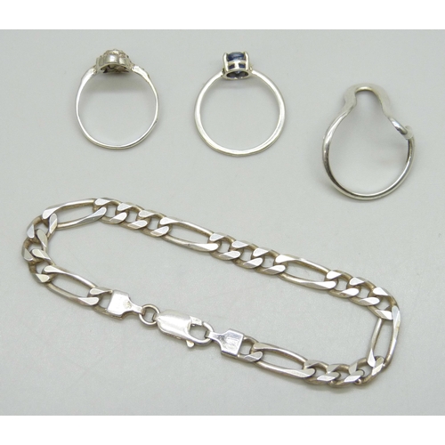 7153 - An Italian silver curb link bracelet, two white metal rings, and a silver ring, all test as silver, ... 