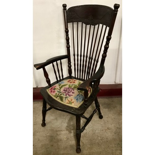 165A - An early 20th Century American carved oak armchair