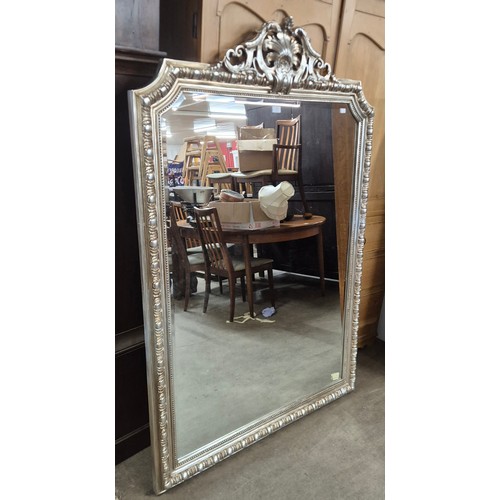 217 - A large French Louis XV style silver effect framed mirror