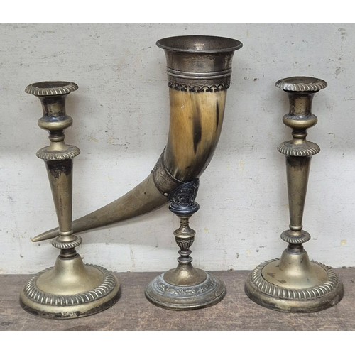 296 - A pair of brass candlesticks and a brass mounted horn on stand