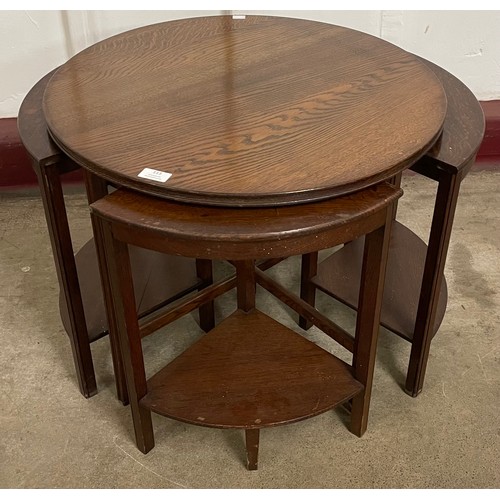 113 - An early 20th Century oak circular nest of tables