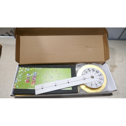 6040 - A box of miscellaneous items including blow up chair, cuckoo clock, trays, door wedge, glass jars, J... 