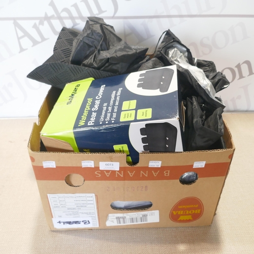 6073 - A box of car accessories to include seat cover, car mats etc. *This lot is subject to VAT
