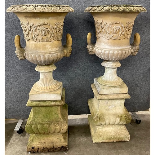 150 - A pair of large Neo-Classical style concrete campana shaped garden urns on stands