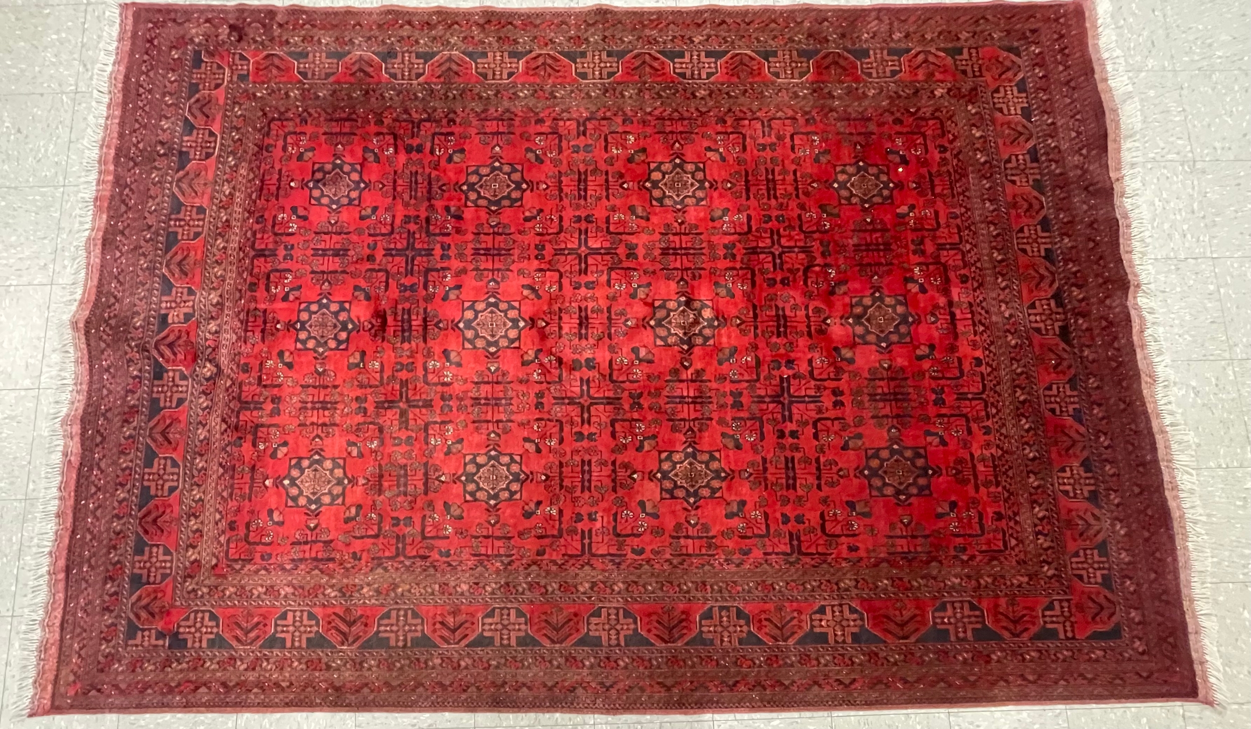 An Iranian red ground rug, 202cm x 310cm